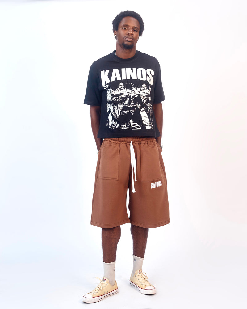 Model wearing the black Won't Back Down T-shirt with brown sweat shorts