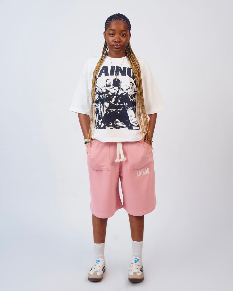 Model wearing the cream Won't Back Down T-shirt with pink sweat shorts