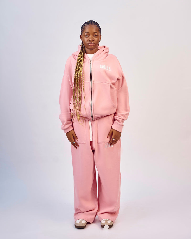 Model wearing the pink zip-up hoodie with matching pink wide-leg sweatpants