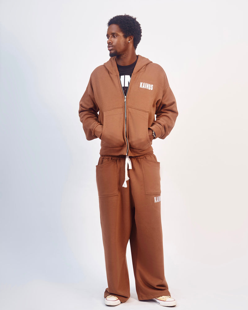 Model wearing the coffee brown zip-up hoodie with matching brown wide-leg sweatpants