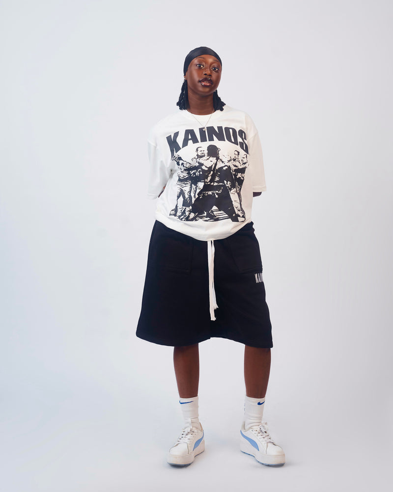 Model wearing the white Won't Back Down T-shirt with black sweat shorts