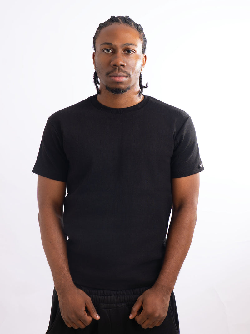 Model wearing the black fitted T-shirt, front view
