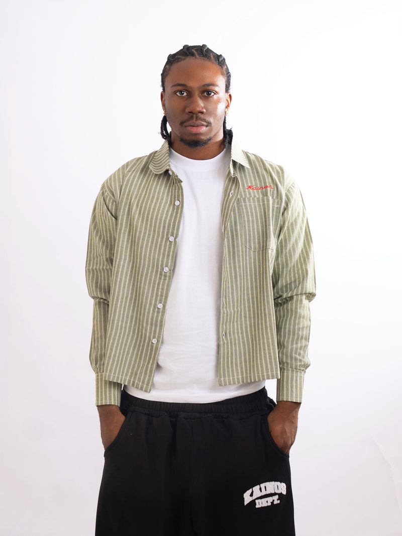 Model wearing the striped shirt open over a white T-shirt with black sweatpants