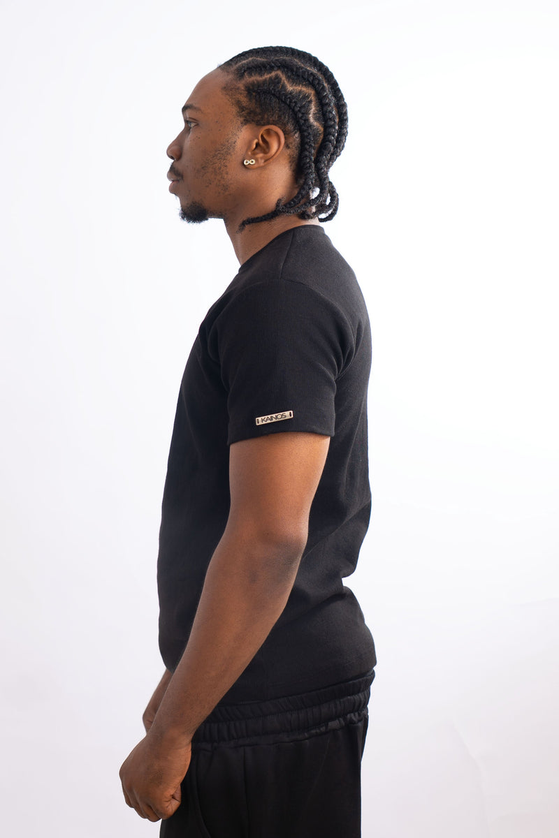 Side view of a model wearing the black fitted T-shirt