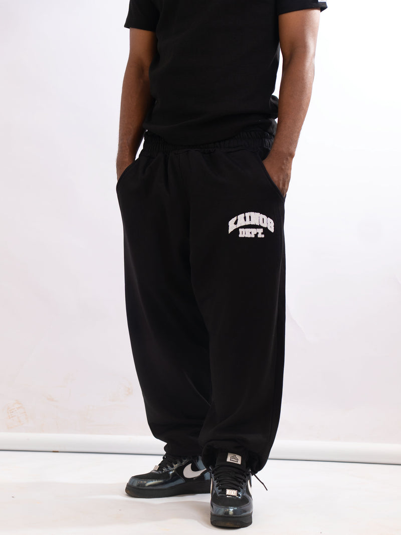 Model wearing the black sweatpants with a black T-shirt and black trainers