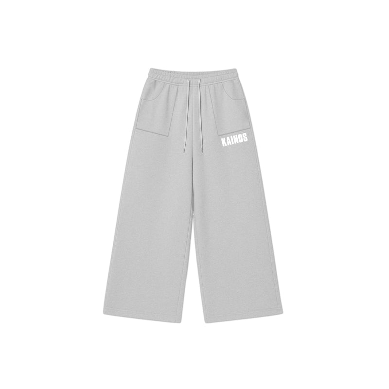 Light grey wide-leg cotton sweatpants with a drawstring waist and KAINOS embroidered in white on the leg